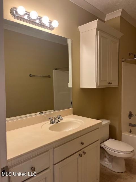 bathroom with tile patterned flooring, toilet, ornamental molding, shower / bathing tub combination, and vanity