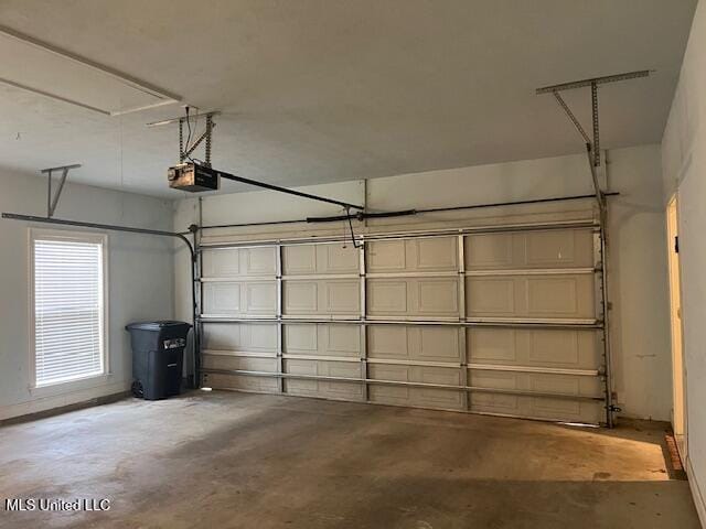 garage with a garage door opener and baseboards