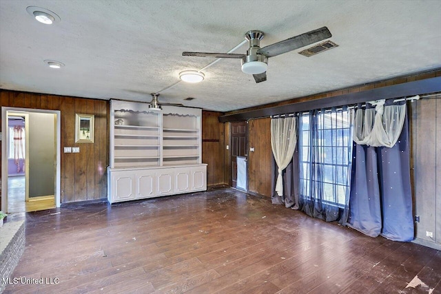 garage featuring wooden walls and ceiling fan