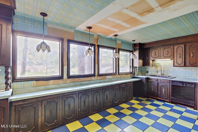 kitchen with decorative light fixtures, dishwasher, sink, and dark brown cabinets