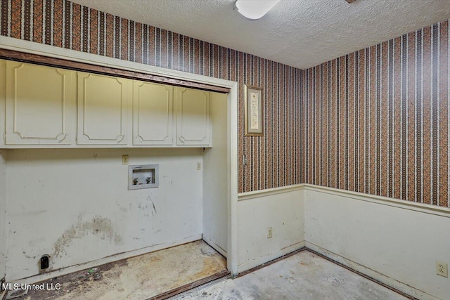 washroom with cabinets, washer hookup, and a textured ceiling