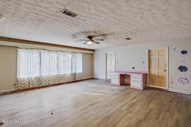 interior space with ceiling fan, hardwood / wood-style floors, and a textured ceiling