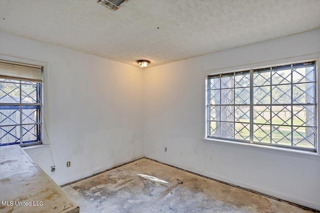 spare room with a textured ceiling