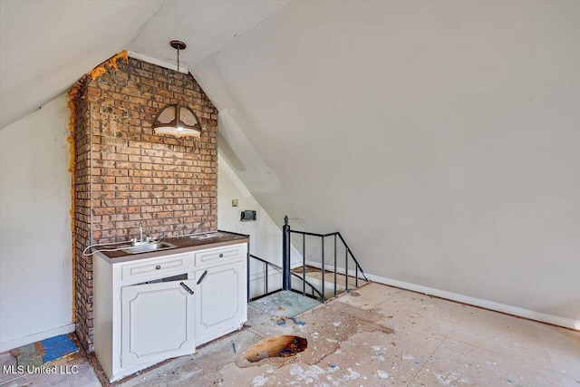 additional living space with lofted ceiling and sink