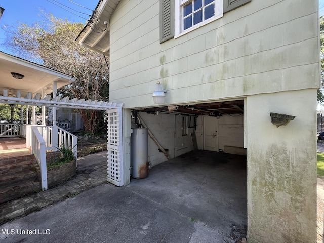 view of side of home with gas water heater