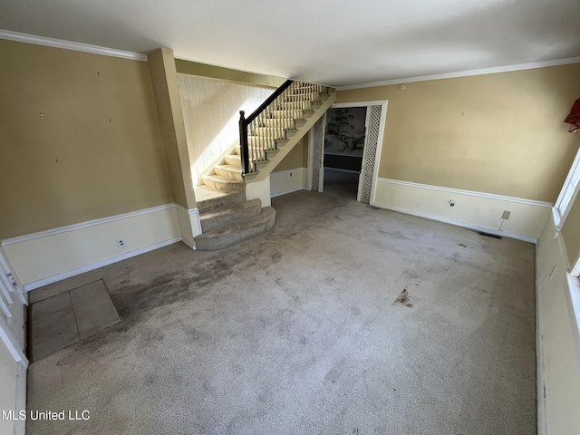 unfurnished living room with ornamental molding and light carpet