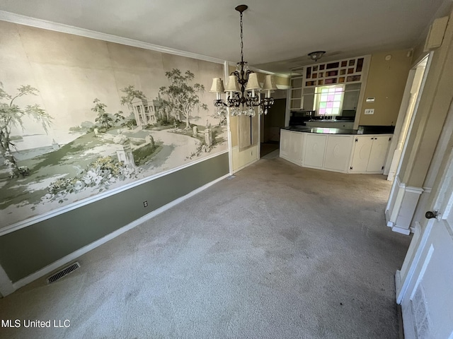 unfurnished dining area featuring ornamental molding, light colored carpet, and a chandelier