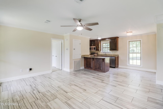 14667 Cable Bridge Rd, Gulfport, MS 39503 - kitchen with appliances with stainless steel finishes, open floor plan, a peninsula, a ceiling fan, and baseboards