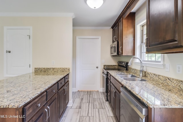 14667 Cable Bridge Rd, Gulfport, MS 39503 - kitchen with stainless steel appliances, a sink, light stone countertops, a peninsula, and dark brown cabinetry
