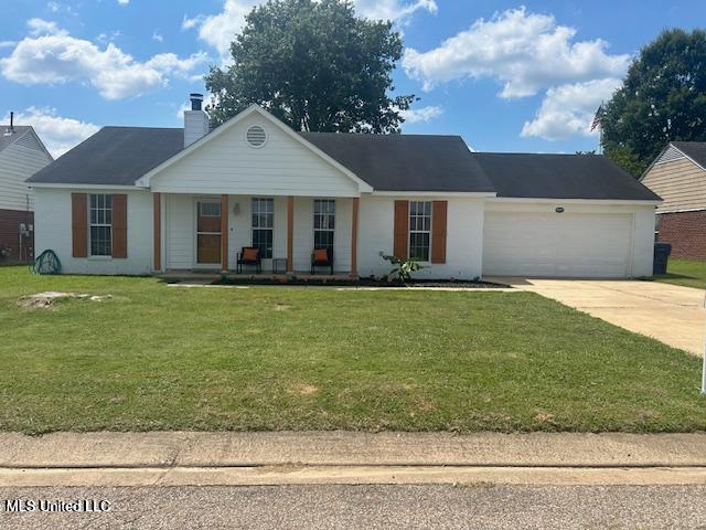 4181 Meadow Creek Dr, Horn Lake, MS 38637 - view of front of property with a porch, an attached garage, concrete driveway, a front lawn, and a chimney