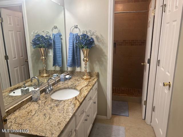 4181 Meadow Creek Dr, Horn Lake, MS 38637 - full bathroom with vanity, a tile shower, and tile patterned floors