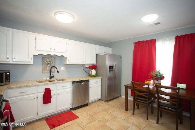 4181 Meadow Creek Dr, Horn Lake, MS 38637 - kitchen featuring stainless steel appliances, white cabinetry, and light stone countertops