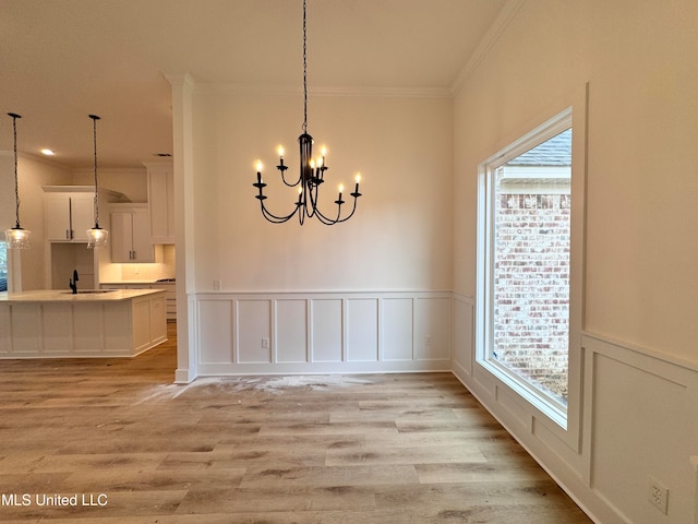 unfurnished dining area with light hardwood / wood-style flooring, plenty of natural light, and sink