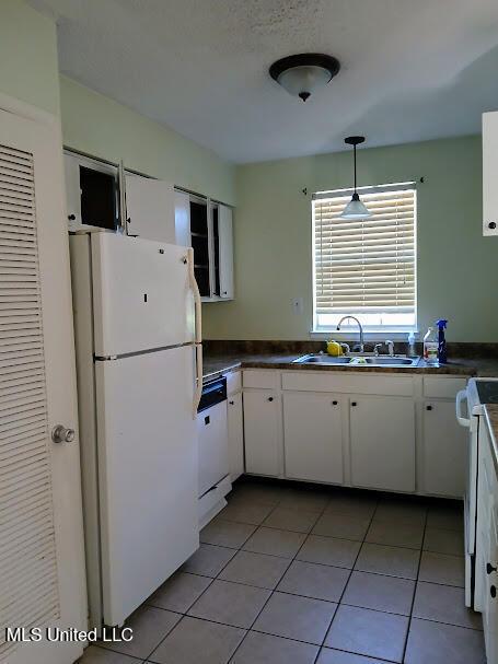 kitchen with sink, white cabinets, and white appliances