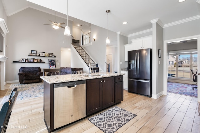 kitchen featuring a center island with sink, wood tiled floor, stainless steel dishwasher, crown molding, and fridge with ice dispenser