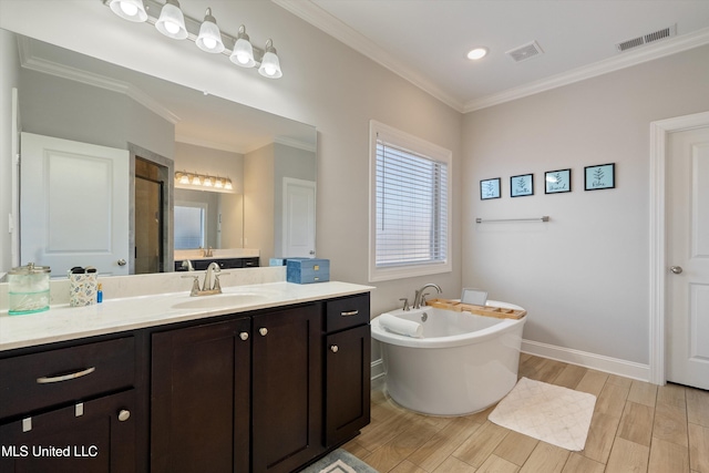 full bath with visible vents, ornamental molding, wood finished floors, a soaking tub, and vanity