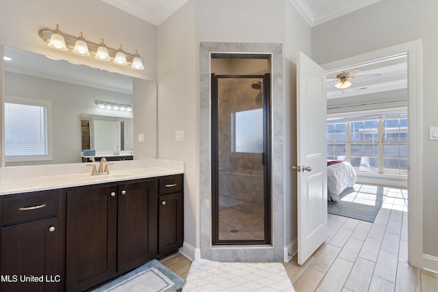 full bathroom featuring vanity, wood finished floors, a shower stall, ensuite bathroom, and crown molding