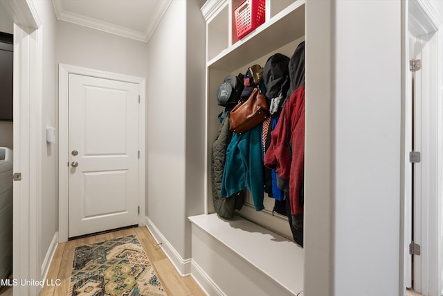 mudroom with crown molding, baseboards, and light wood finished floors