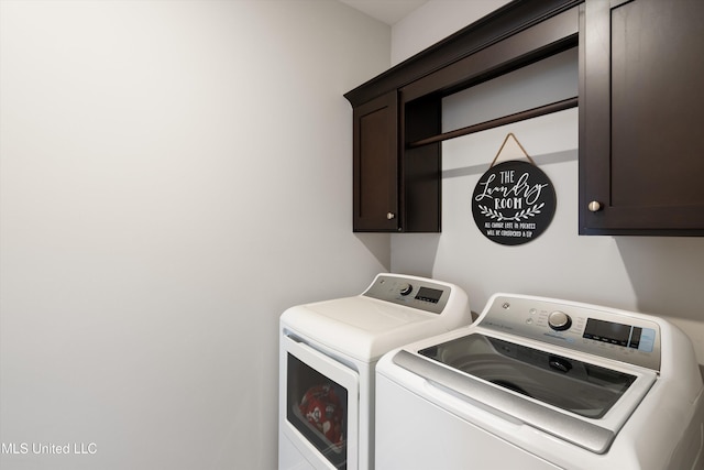 washroom with cabinet space and washing machine and dryer