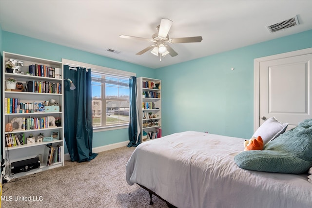 carpeted bedroom featuring visible vents, baseboards, and ceiling fan