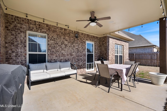 view of patio / terrace with outdoor dining space, an outdoor living space, a ceiling fan, and fence