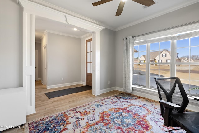 office space featuring light wood finished floors, ceiling fan, baseboards, and ornamental molding