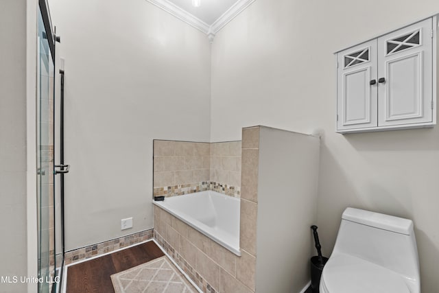 bathroom featuring tiled tub, toilet, crown molding, and hardwood / wood-style floors