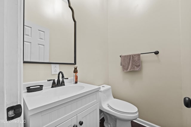 bathroom with toilet and vanity