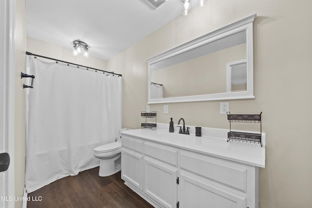 bathroom with toilet, wood-type flooring, and vanity