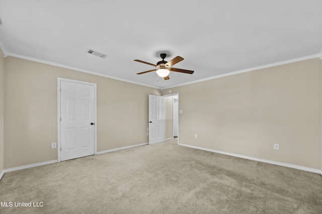 unfurnished room with ceiling fan, light carpet, and crown molding