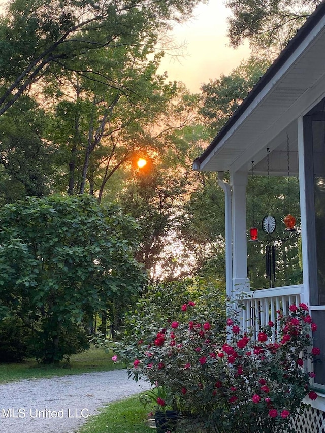 property exterior at dusk with covered porch