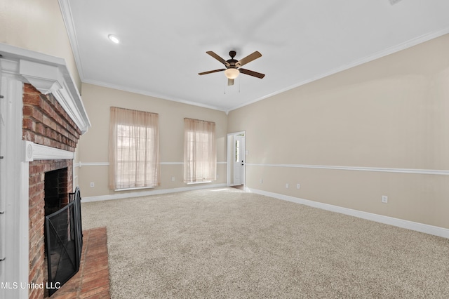 unfurnished living room featuring ceiling fan, a fireplace, carpet floors, and crown molding