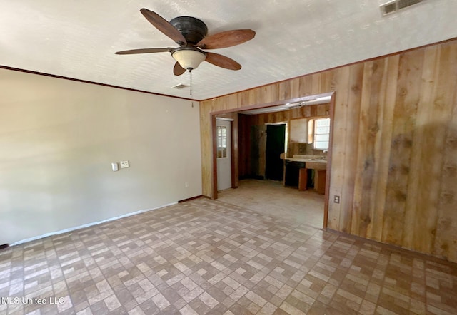 307 Pleasant Valley Dr, Vicksburg, MS 39180 - unfurnished room with wood walls, brick patterned floors, ceiling fan, and baseboards