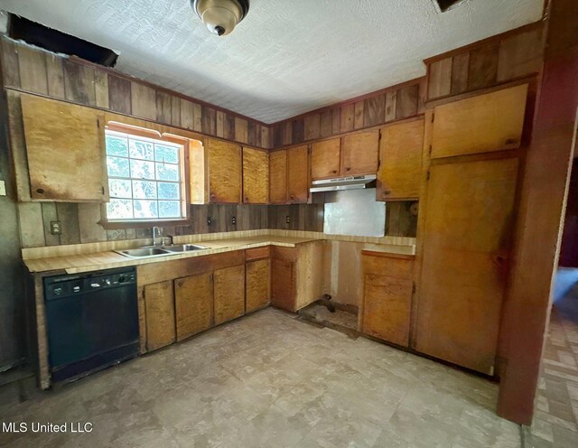 307 Pleasant Valley Dr, Vicksburg, MS 39180 - kitchen with dishwasher, a sink, under cabinet range hood, brown cabinets, and wooden walls