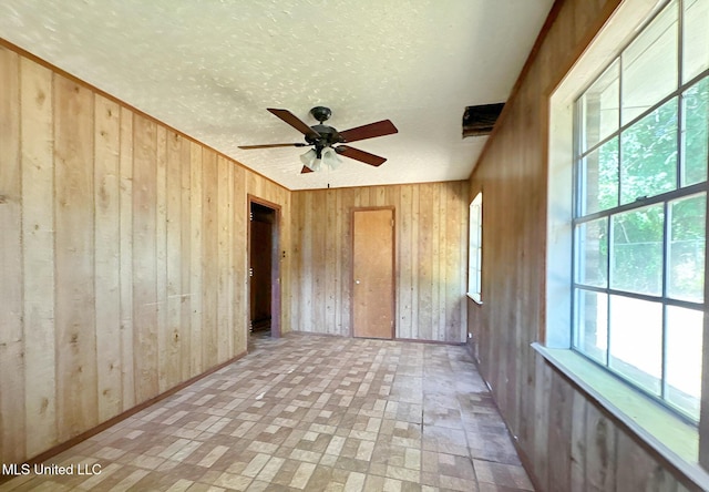 307 Pleasant Valley Dr, Vicksburg, MS 39180 - unfurnished bedroom with wood walls, multiple windows, and brick patterned flooring