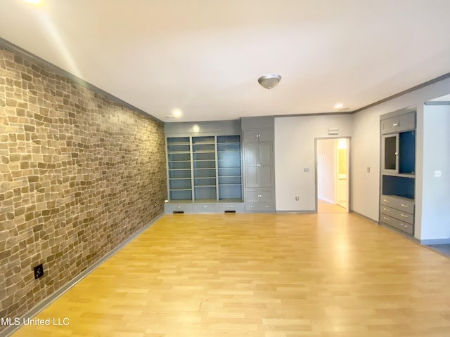 unfurnished room with light hardwood / wood-style floors and crown molding