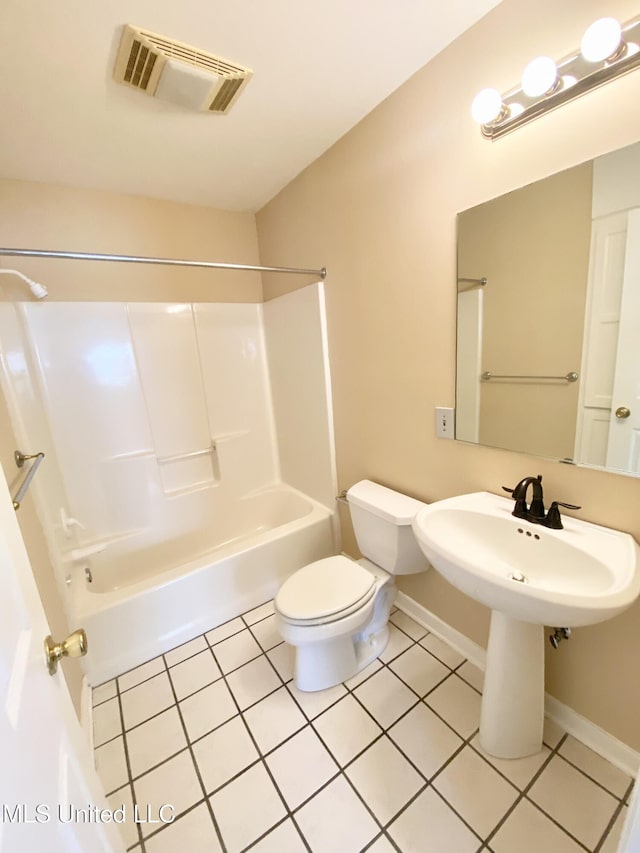 bathroom with shower / tub combination, tile patterned flooring, and toilet