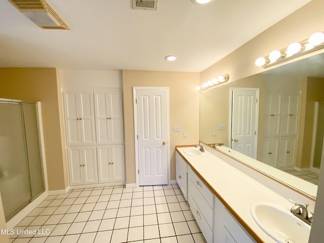 bathroom with vanity, tile patterned floors, and a shower with shower door