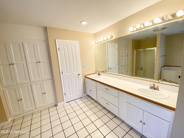 bathroom with tile patterned flooring, vanity, and an enclosed shower