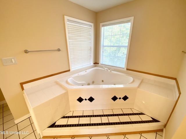 bathroom featuring tiled bath and tile patterned flooring