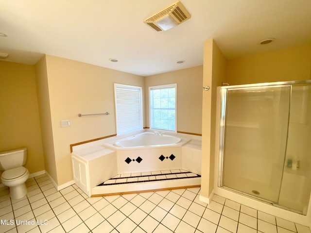 bathroom featuring tile patterned flooring, toilet, and independent shower and bath