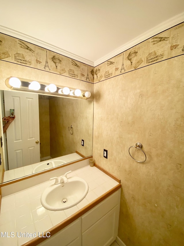 bathroom featuring crown molding and vanity