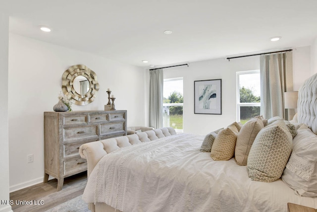 bedroom featuring light hardwood / wood-style floors and multiple windows