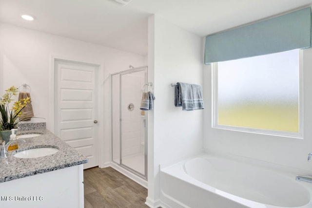 bathroom featuring vanity, separate shower and tub, and wood-type flooring