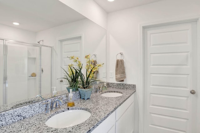 bathroom featuring vanity and an enclosed shower