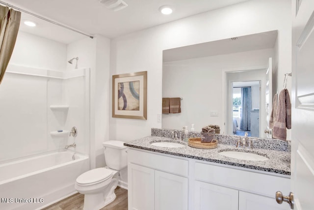 full bathroom featuring vanity, shower / tub combo, hardwood / wood-style flooring, and toilet