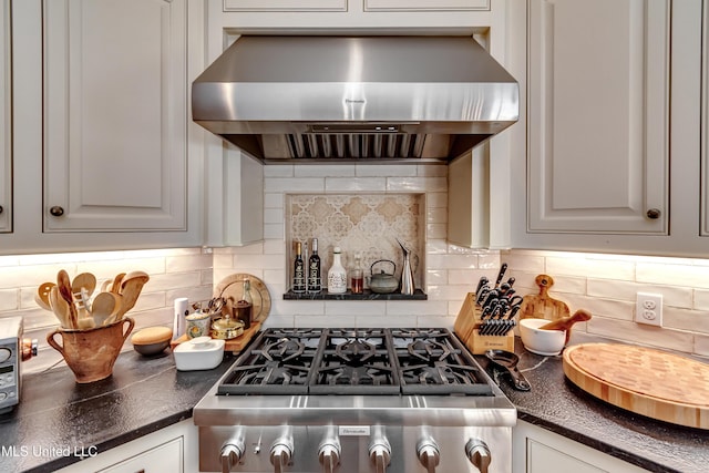 kitchen featuring white cabinets, stainless steel gas cooktop, decorative backsplash, and wall chimney range hood