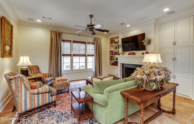 living room featuring ceiling fan, ornamental molding, and built in features