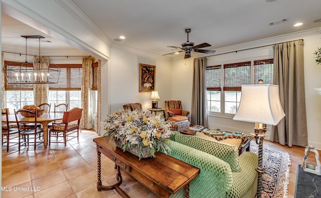 living room featuring ceiling fan with notable chandelier, crown molding, and light tile patterned flooring