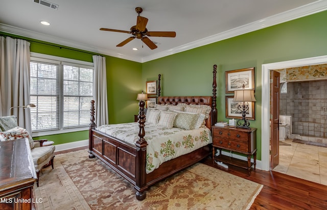 bedroom featuring ceiling fan, wood-type flooring, ornamental molding, and ensuite bath